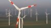 FILE - Wind turbines produce green energy in Nauen near Berlin, Germany.