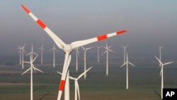 Wind turbines produce green energy in Nauen near Berlin, Germany.