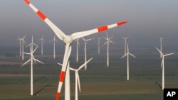 FILE - Wind turbines produce green energy in Nauen near Berlin, Germany.