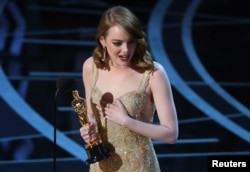 Best Actress winner Emma Stone accepts her award for La La Land.