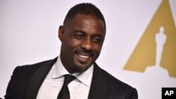 FILE - Actor Idris Elba, pictured at the Oscars in Los Angeles on Feb. 22, 2015, is one of 700 people invited to join the voting board of the Academy of Motion Picture Arts and Sciences.