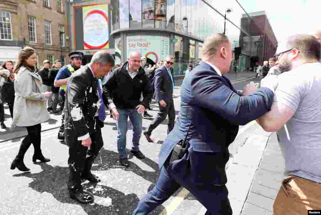 Brexit Party leader Nigel Farage is hit with a milkshake drink while arriving for a Brexit Party campaign event in Newcastle.