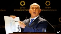 Israeli Prime Minister Benjamin Netanyahu shows a map from U.S. President Donald Trump's son-in-law Jared Kushner during statements to the press in Jerusalem, May 30, 2019.