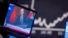 FILE - Russian President Vladimir Putin appears on a television screen at the stock market in Frankfurt, Germany, Feb. 25, 2022.