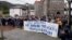 FILE - People stand behind a banner reading "Freedom for our neighbor Pablo Gonzalez. Press Freedom," during a demonstration, after Gonzalez was detained by Polish authorities on espionage charges, in Nabarniz, Spain, March 6, 2022.