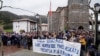 People stand behind a banner reading 'Freedom for our neighbor Pablo Gonzalez. Press Freedom,' during a demonstration, after Gonzalez was detained by Polish authorities on espionage charges, in Nabarniz, Spain, March 6, 2022.