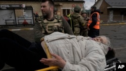 An elderly woman lies on a stretcher in Irpin, on the outskirts of Kyiv, Ukraine, March 8, 2022.