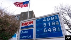 Prices for a gallon of gasoline are posted on the sign of an Exxon gas station, in the Capitol Hill neighborhood of Washington, March 7, 2022.