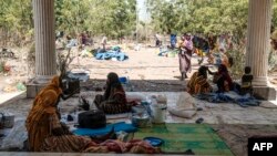 FILE - People rest at the entrance of the Agda Hotel, in the city of Semera, Afar region, Ethiopia, Feb. 14, 2022. 