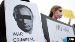 Slavic people living in Taiwan display posters during a protest against Russia's military invasion of Ukraine at the Free Square outside the Chiang Kai-shek Memorial Hall on March 6, 2022.