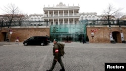 FILE - A member of the Austrian armed forces walks past Palais Coburg, site of talks on the Iran nuclear deal, in Vienna, Austria, Feb. 8, 2022.