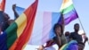 FILE - Dozens of people cheer and dance as they take part in the Namibian Lesbians, Gay, Bisexual and Transexual (LGBT) community pride Parade in the streets of the Namibian capital on July 29, 2017 in Windhoek. 