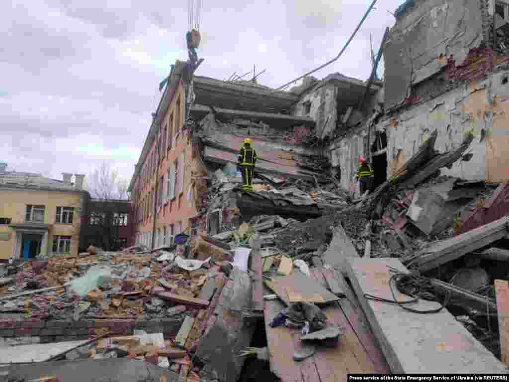 Rescuers remove debris from a school building damaged by shelling in Chernihiv, March 7, 2022.