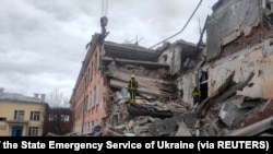 Rescuers remove debris from a school building damaged by shelling, amid the Russian invasion of Ukraine, in Chernihiv, Ukraine, in this handout picture released March 7, 2022.