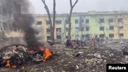Cars and a building of a hospital destroyed by an aviation strike amid Russia's invasion of Ukraine are seen in Mariupol, Ukraine, in this handout picture released March 9, 2022. (Press service of the National Police of Ukraine/Handout via Reuters)