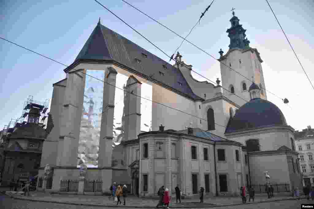 A view shows shields on the facade of a cathedral, attached to protect ancient glass windows in case of an assault during Ukraine-Russia conflict, in Lviv, March 8, 2022.