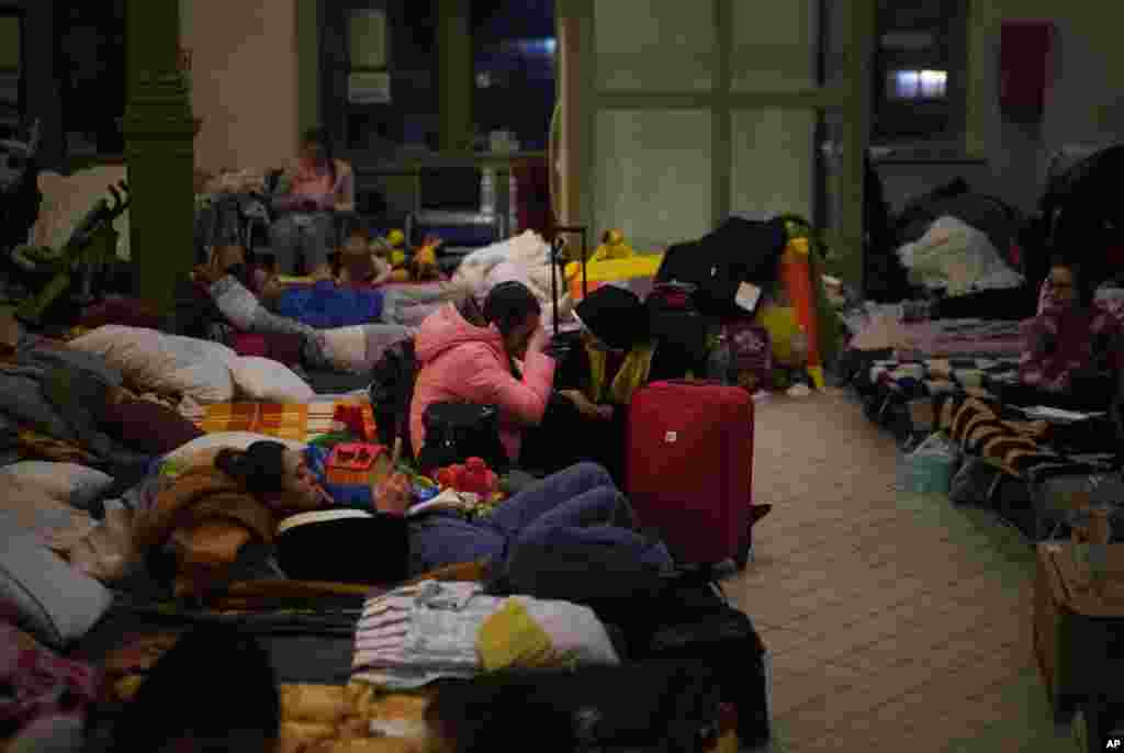 A nun comforts a child at a temporary shelter, for displaced persons fleeing Ukraine, in Przemysl, Poland, March 8, 2022.