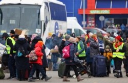 People arrive a temporary accommodation and transport hub for refugees at a former shoping mall, after fleeing the Russian invasion of Ukraine, in Przemysl, Poland, March 6, 2022.