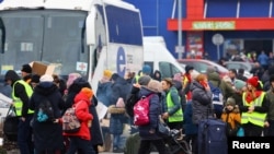 People arrive a temporary accommodation and transport hub for refugees at a former shoping mall, after fleeing the Russian invasion of Ukraine, in Przemysl, Poland, March 6, 2022. 