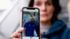 Oihana Goiriena, wife of journalist Pablo Gonzalez, shows a picture of her husband on her phone, after he was detained by Polish authorities on espionage charges, in Nabarniz, Spain, March 5, 2022.