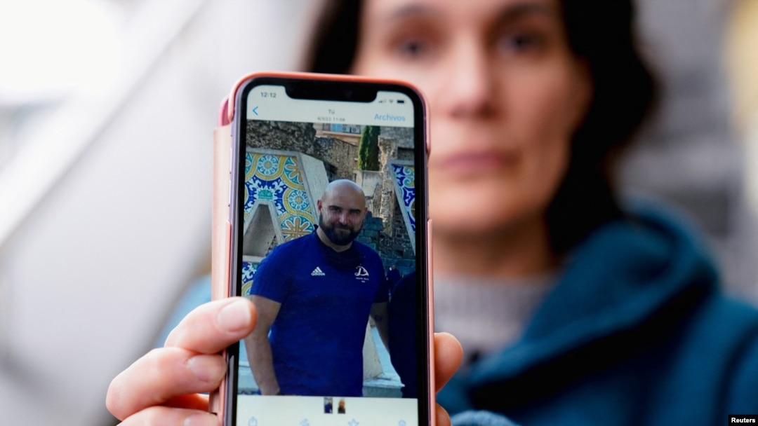 FILE - Oihana Goiriena, wife of journalist Pablo Gonzalez, shows a picture of her husband on her phone, after he was detained by Polish authorities on espionage charges, in Nabarniz, Spain, March 5, 2022.