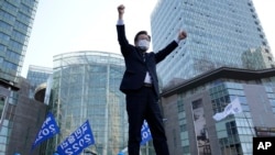 Lee Jae-myung, the presidential election candidate of the ruling Democratic Party, greets supporters upon his arrival for a presidential election campaign in Seoul, South Korea, Thursday, March 3, 2022. (AP Photo/Lee Jin-man)