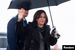 U.S. Vice President Kamala Harris waves as she arrives to board the Air Force Two as she departs for a three-day trip to Poland and Romania for meetings on Russia's invasion of Ukraine, at Joint Base Andrews, in Maryland, March 9, 2022.