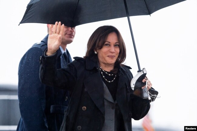 U.S. Vice President Kamala Harris waves as she arrives to board the Air Force Two as she departs for a three-day trip to Poland and Romania for meetings on Russia's invasion of Ukraine, at Joint Base Andrews, in Maryland, March 9, 2022.
