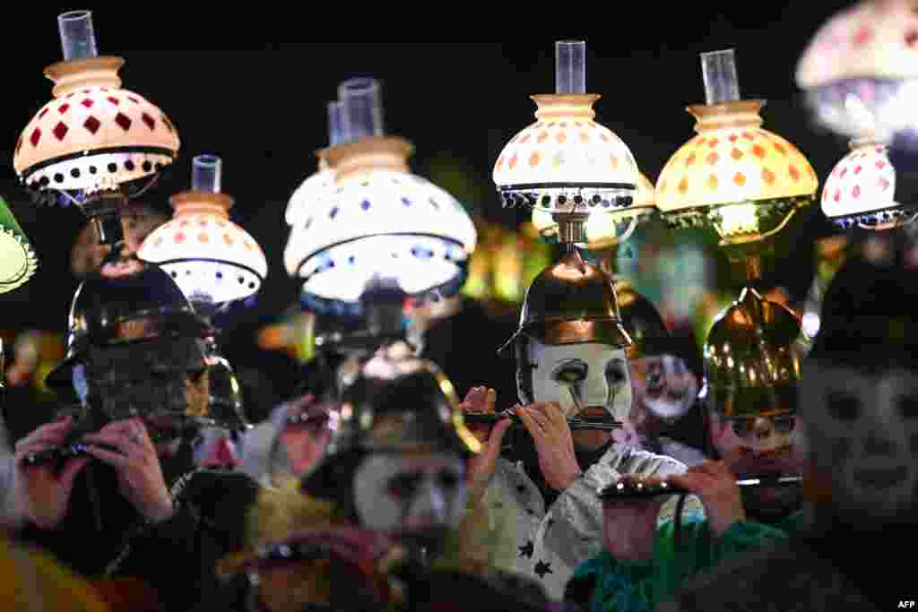 Revelers parade with lanterns during the traditional &quot;Morgenstreich&quot; procession starting the carnival of Basel, Switzerland.