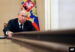 Russian President Vladimir Putin chairs a meeting with members of the government via teleconference in Moscow, March 10, 2022.