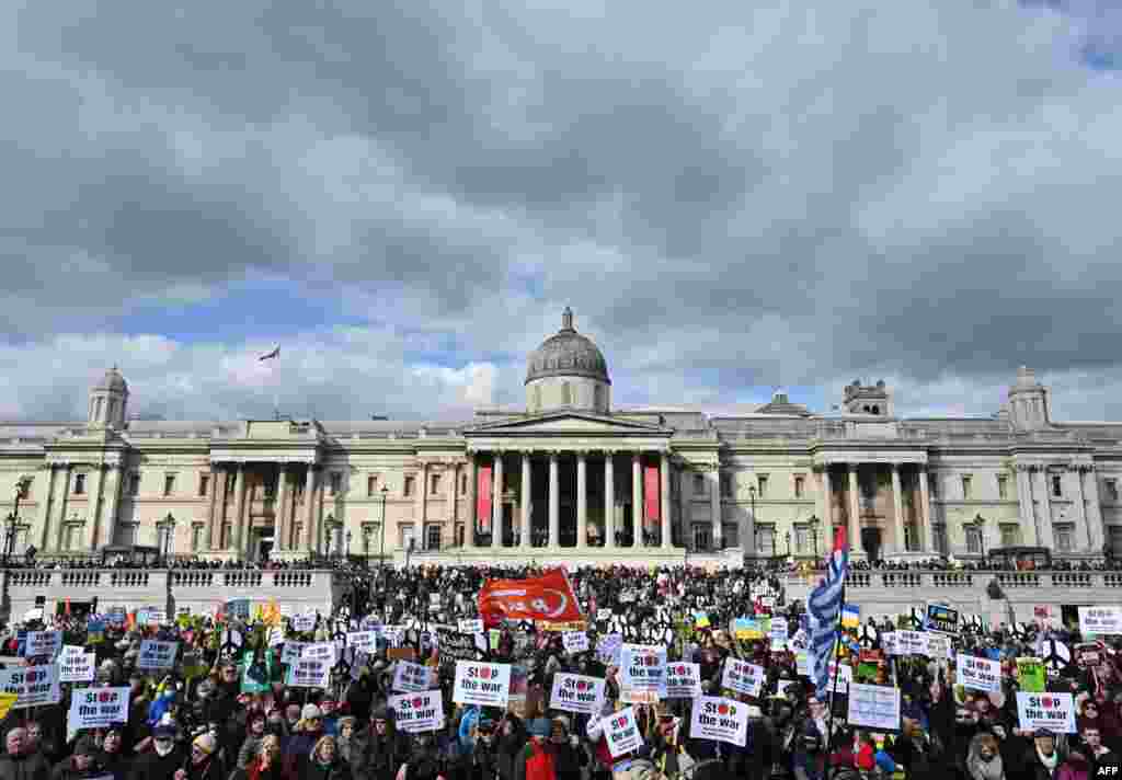 Demonstrators hold up placards in Trafalgar Square during a rally for a Stop the War in Ukraine Global Day of Action, in central London.