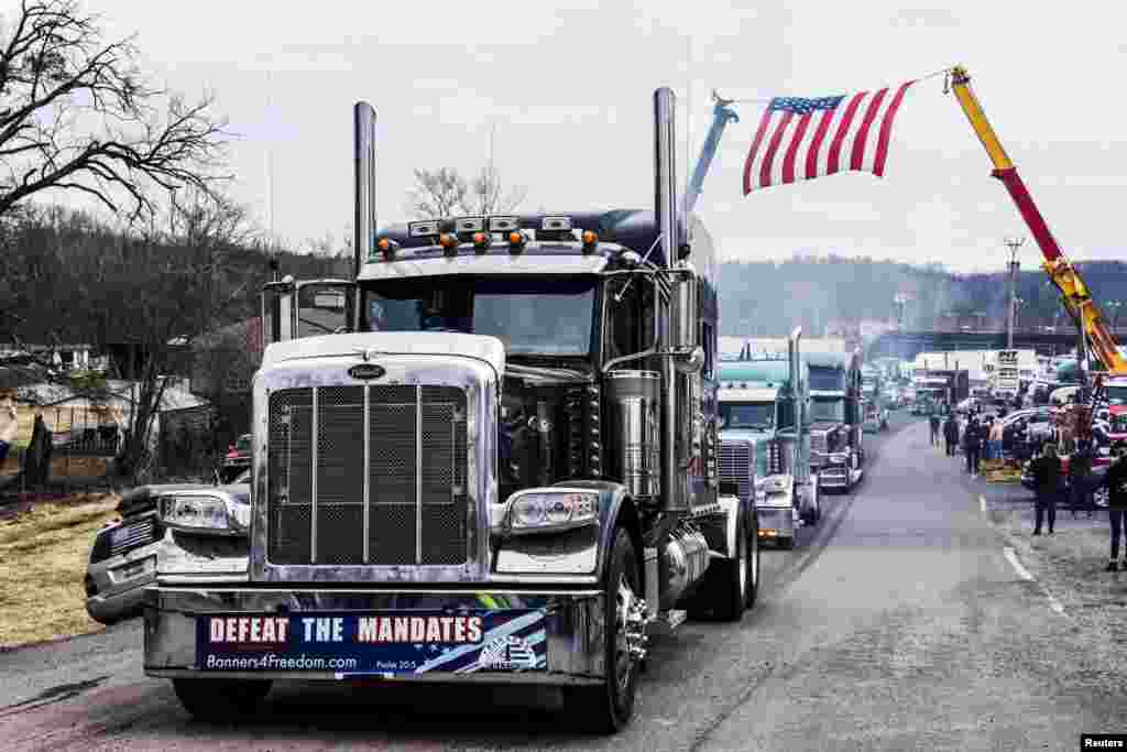 Hundreds of vehicles, including 18-wheeler trucks, RVs and other cars depart the Hagerstown Speedway in Hagerstown, Maryland, as part of a convoy that traveled across the country headed to Washington D.C. to protest COVID-19 related mandates and other issues.