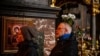 John and Natasha from the US pray during a morning mass at St. Vladimir's Cathedral in Kyiv on March 5, 2022.