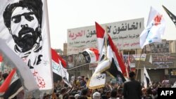 Iraqis demonstrate to denounce rising prices of basic food items, in al-Haboubi Square in the center of Iraq's city of Nasiriyah in the southern Dhi Qar province on March 9, 2022. 