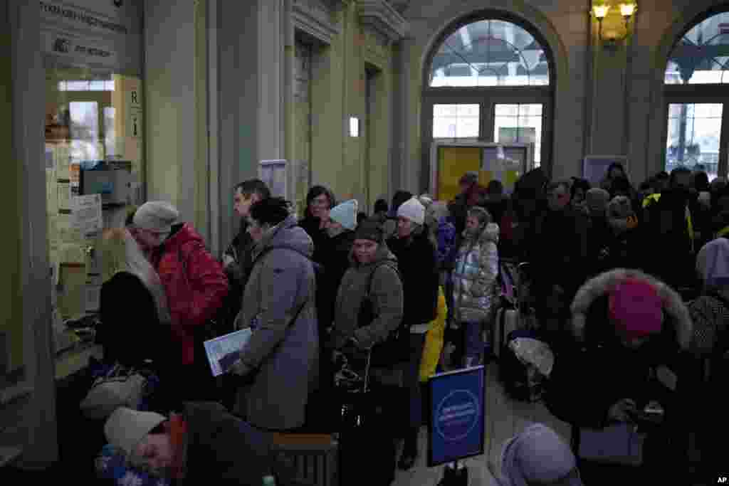 People who fled the war from neighboring Ukraine buy train tickets at the Przemysl train station in Przemysl, Poland, March 9, 2022.