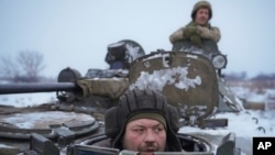 FILE - Ukrainians drive an armored personnel carrier in the Luhansk area, Jan. 28, 2022. On March 11, 2022, Ukrainian President Volodymyr Zelenskyy said in a broadcast video without elaborating that his military had reached a “strategic turning point" in its war with Russia.