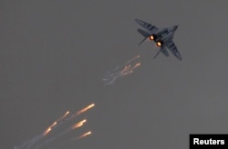 FILE - A Polish Air Force MiG-29 jet fires flares during a demonstration flight at the Radom Air Show, at Radom airport, Poland, Aug. 24, 2013.