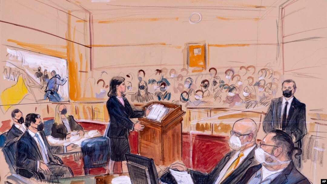 This artist sketch depicts Guy Wesley Reffitt, bottom right, joined by his lawyer William Welch, third from right, listening to prosecutor Risa Berkower, in Federal Court in Washington, March 7, 2022.