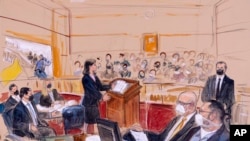 This artist sketch depicts Guy Wesley Reffitt, bottom right, joined by his lawyer William Welch, third from right, listening to prosecutor Risa Berkower, in Federal Court in Washington, March 7, 2022.