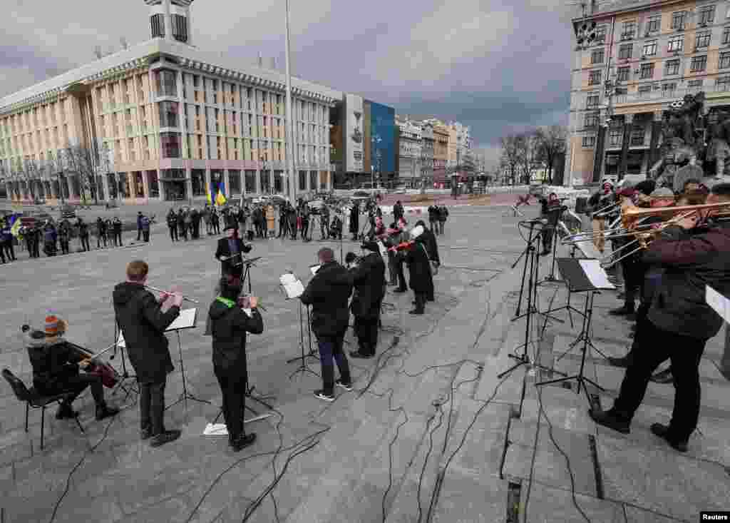 Musicians of the Kyiv-Classic Symphony Orchestra under the direction of conductor Herman Makarenko perform during an open-air concert named &quot;Free Sky&quot; at the Independence Square in central Kyiv, March 9, 2022.