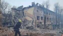 This handout picture released by the State Emergency Service of Ukraine on March 11, 2022, shows rescuers working at the scene of an airstrike in Dnipro.
