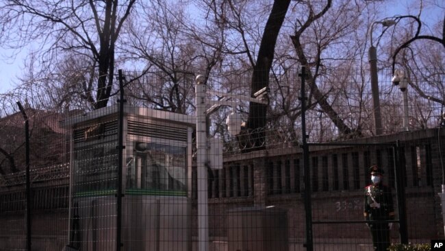 A Chinese paramilitary policeman stands guard along the fences around the Russian Embassy in Beijing on Tuesday, March 1, 2022. (AP Photo/Ng Han Guan)