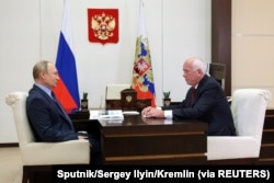 FILE - Russian President Vladimir Putin meets with Rostec CEO Sergey Chemezov at the Novo-Ogaryovo state residence outside Moscow, June 24, 2021.
