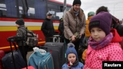 People fleeing the Russian invasion of Ukraine wait for transport after arriving in Slovakia, at a border crossing in Vysne Nemecke, Slovakia, March 5, 2022. 