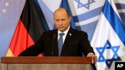 FILE: Israel's Prime Minister Naftali Bennett listens during a press conference with German Chancellor Olaf Scholz in Jerusalem, March 2, 2022.