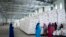 FILE - Workers clean the floor as sacks of food earmarked for the Tigray and Afar regions sits in piles in a warehouse of the World Food Programme (WFP) in Semera, the regional capital for the Afar region, in Ethiopia, Feb. 21, 2022. 