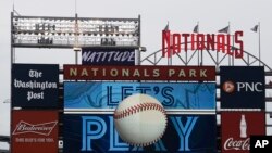 FILE - The scoreboard plays the seventh inning stretch themes of the Toronto Blue Jays during the middle of the seventh inning of a baseball game between the Blue Jays and the Washington Nationals, on July 30, 2020, in Washington.