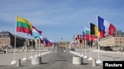 Flags of member countries flutter ahead of a summit of European Union leaders at the Versailles Palace, near Paris, France, March 10, 2022. 