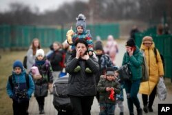 Refugees, mostly women with children, arrive at the border crossing in Medyka, Poland, March 5, 2022, after fleeing Russia's invasion of Ukraine.