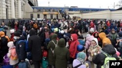 People wait for a train to Poland at the railway station of the western Ukrainian city of Lviv, March 6, 2022, 11 days after Russia launched a military invasion on Ukraine. 